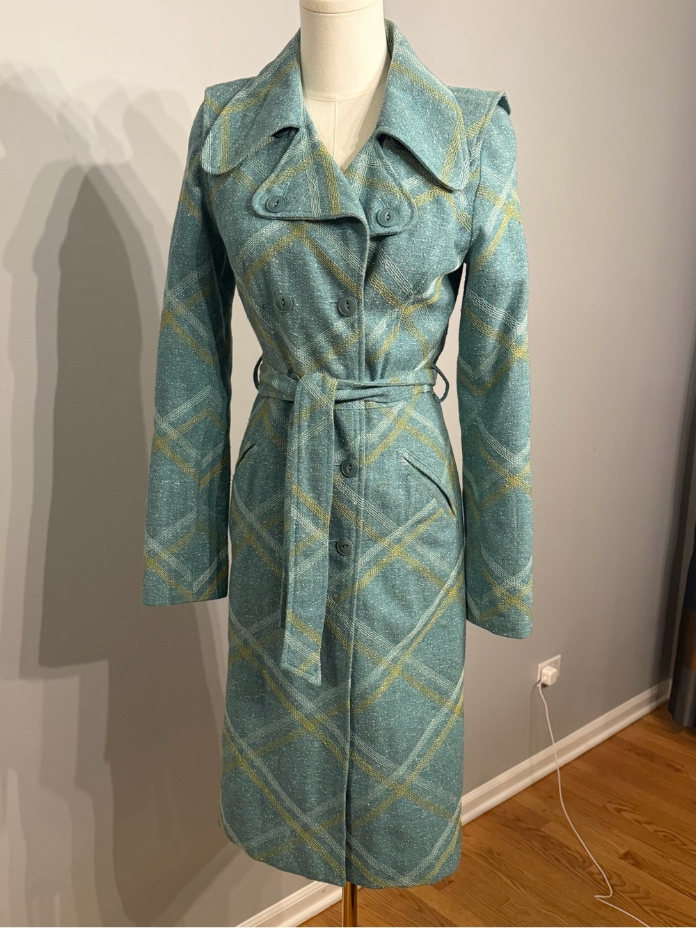 Beth Bowley teal Jacket and skirt featuring mustard and white embroidery.